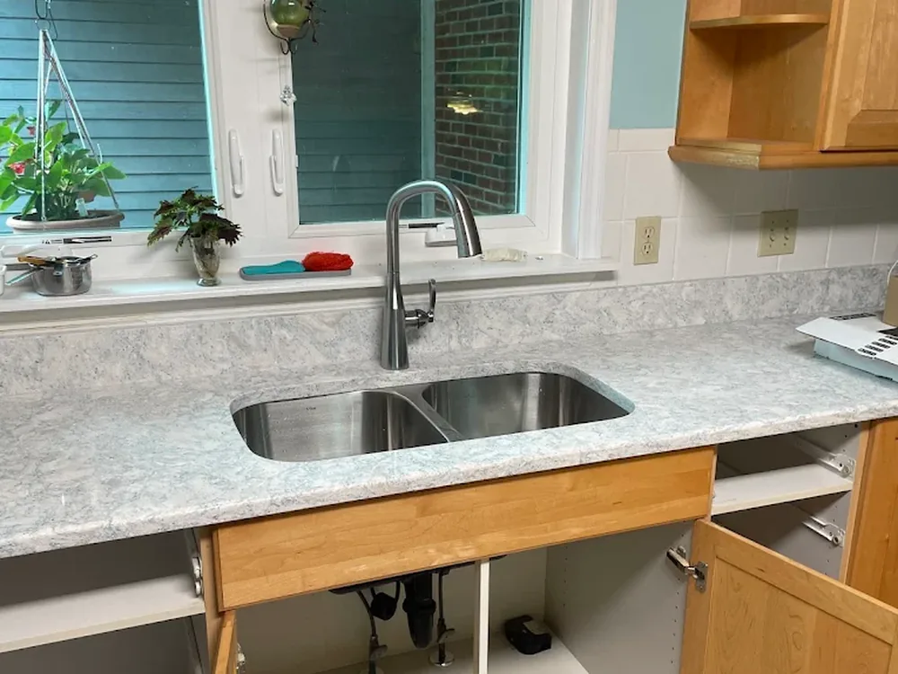 Undermount stainless double sink and faucet in a granite countertop
