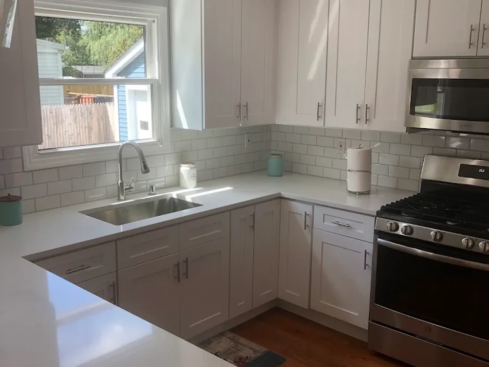 New kitchen sink and pull-down faucet installed under a window