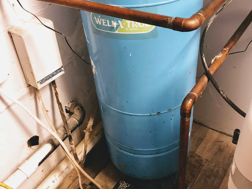 Well pressure tank with new copper piping in a basement